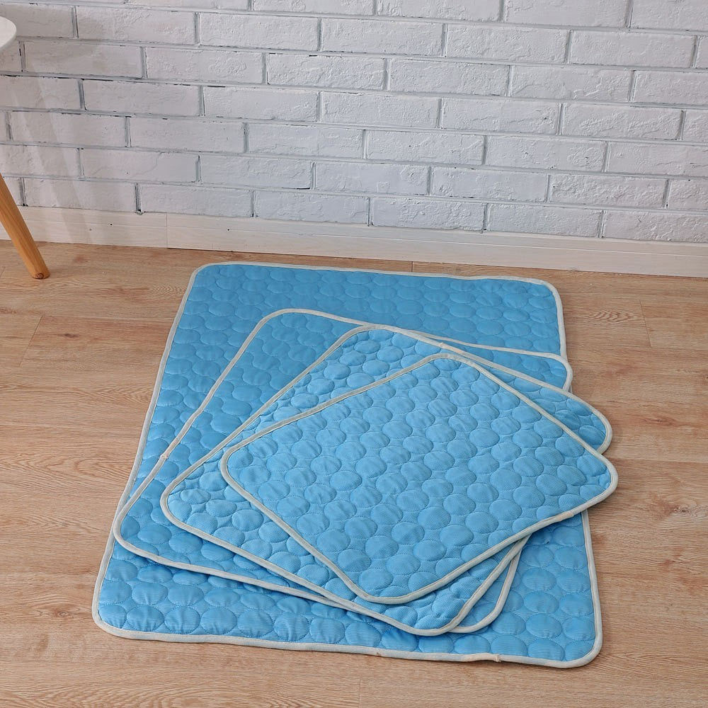 Set of blue dog cool pad cushion mats, folded with quilted bubble texture