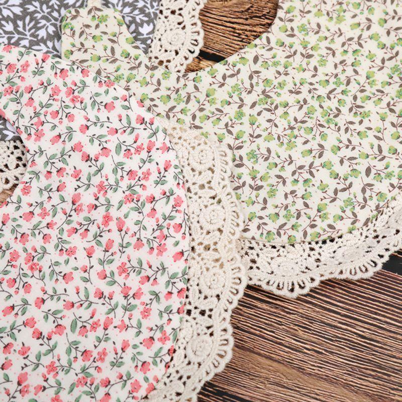 Infant bib with floral print and scalloped lace edging