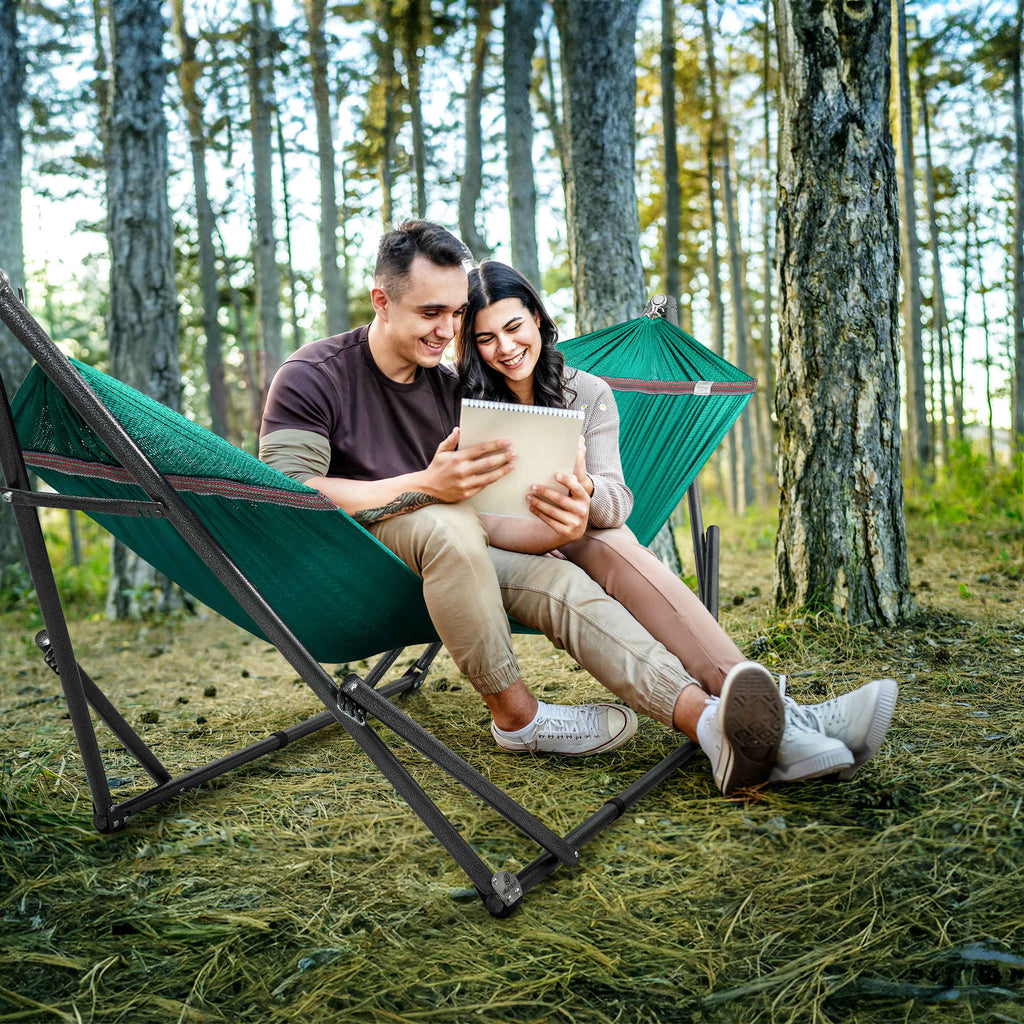 Green outdoor hammock with black folding stand and two seated people