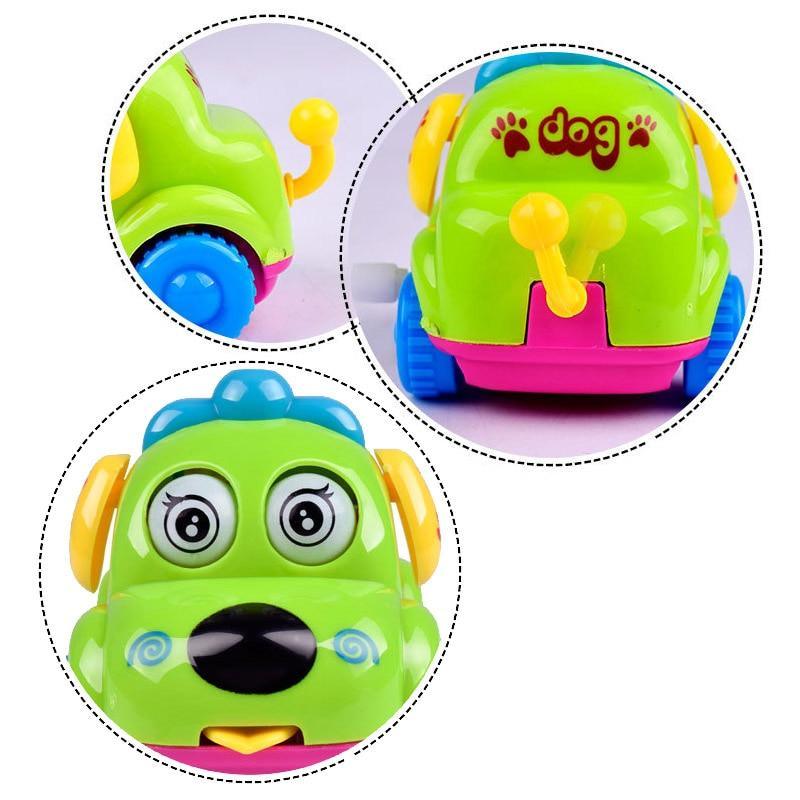 Green cartoon dog wind-up toy car with paw-print panel, large eyes, and open smile