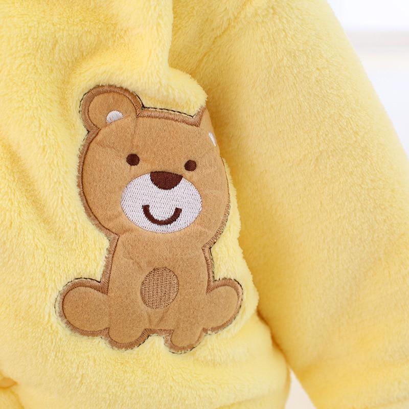 Yellow plush baby romper with teddy-bear applique patch on the sleeve