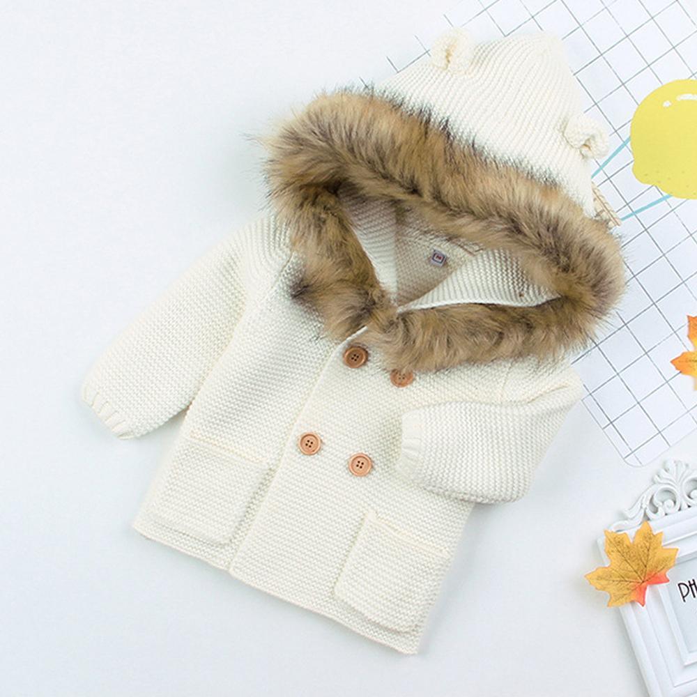 Cream/ivory knit hooded baby jacket with faux fur trim and button front