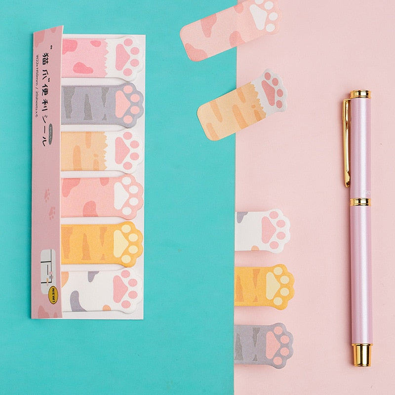 Cat paw sticky note sheets with pastel paw tabs, plus a matching pink pen