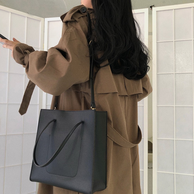 Brown double-breasted long overcoat with large sleeves and belt ties