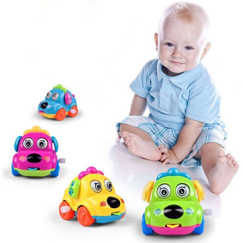 Set of four cartoon dog wind-up toy cars in blue, green, yellow, and pink