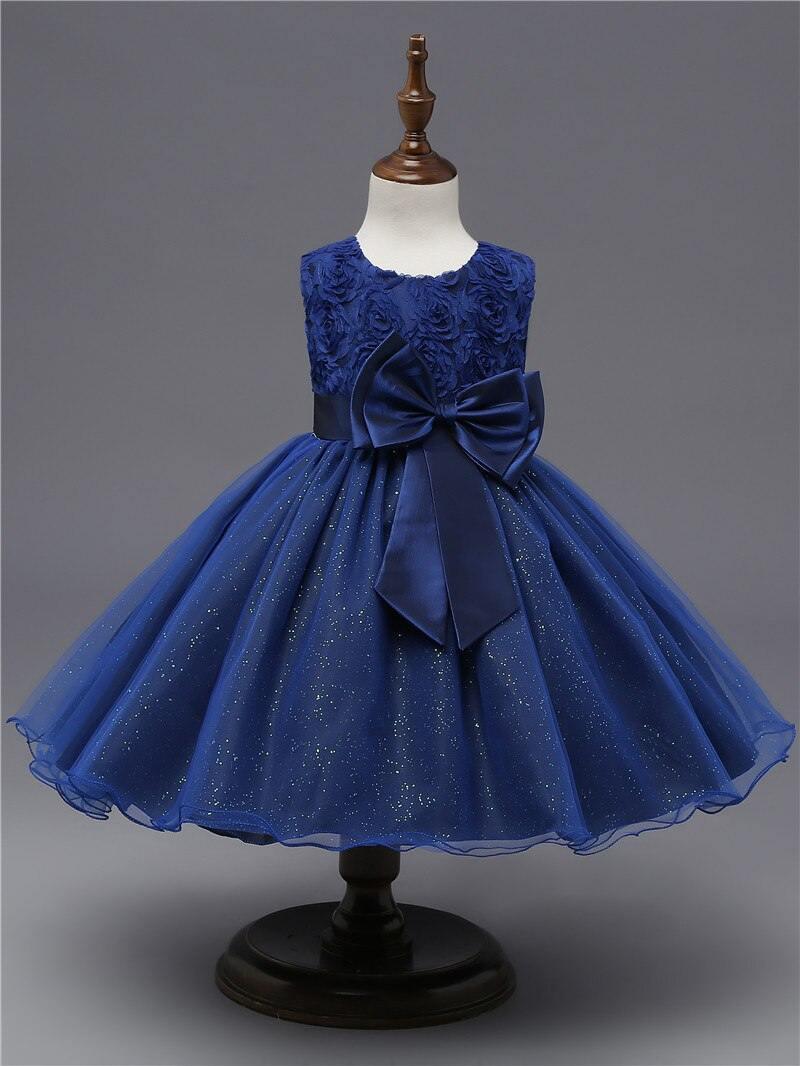 Navy blue tulle dress with dark satin bow and textured glitter finish