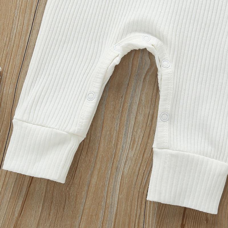 White newborn ribbed romper with snap button waist and open leg cutout