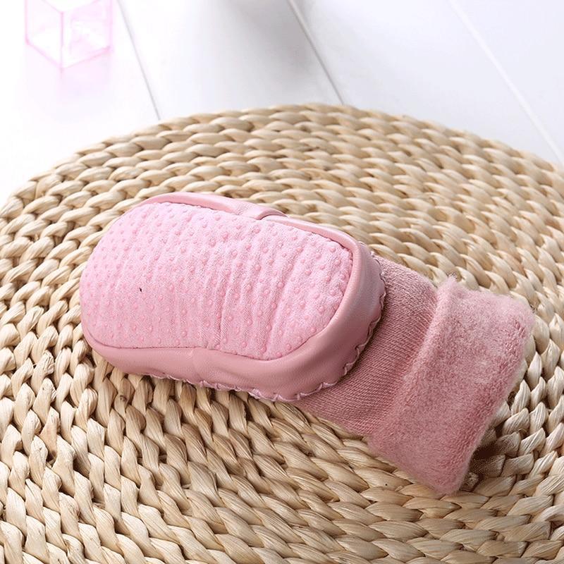 Newborn baby shoes in pale pink plush with padded cuff and stitched outer trim