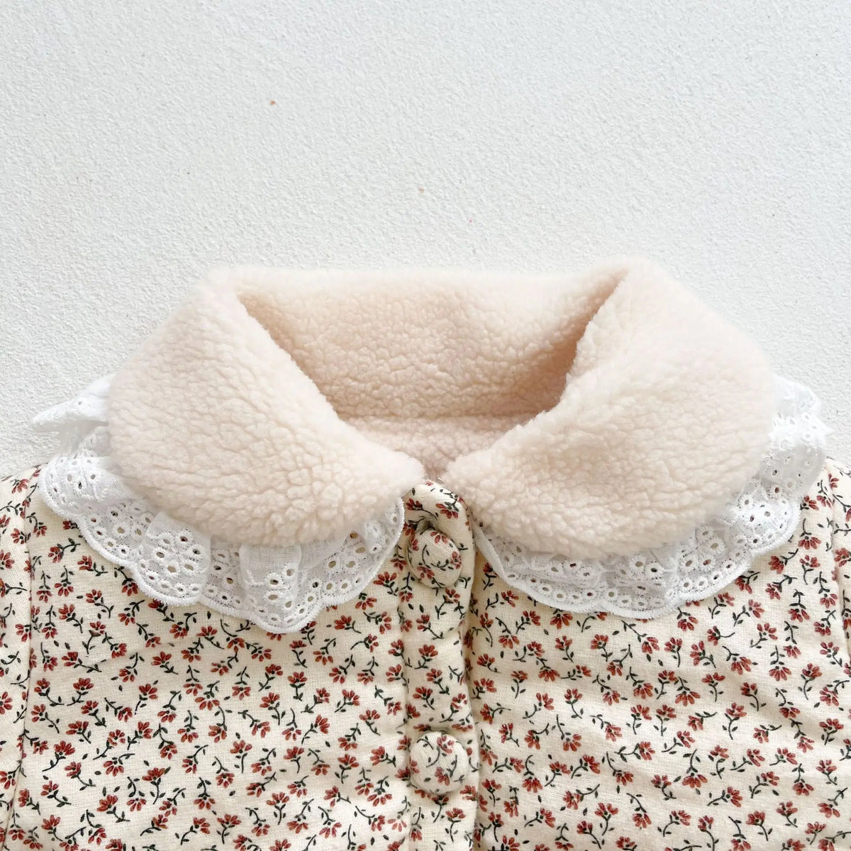 Cream lamb-sherpa collar with eyelet ruffle on floral baby jacket
