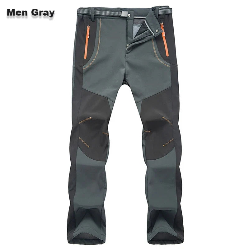Men's gray hiking pants front view with zip pockets and orange contrast trim