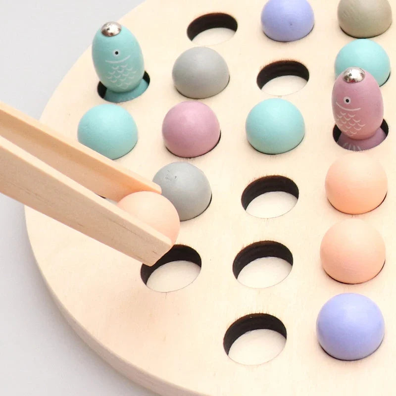 Close-up of round bead counting board with holes and pastel fish magnets