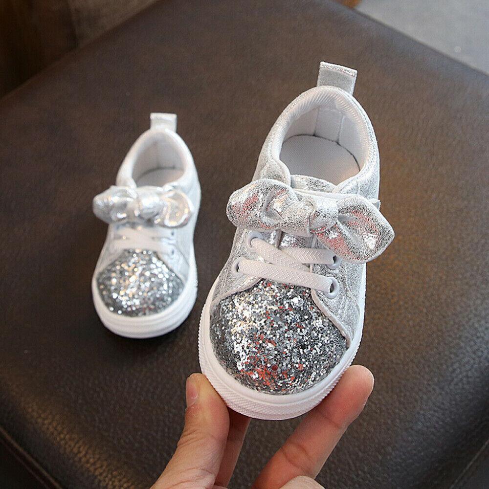 Girls silver glitter lace-up sneakers with bow detail, white rubber sole.