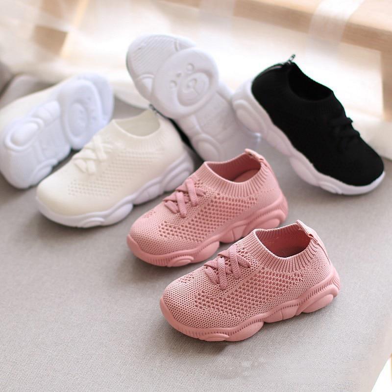 Set of baby knit sneakers in pink, white, and black with lace-up styling