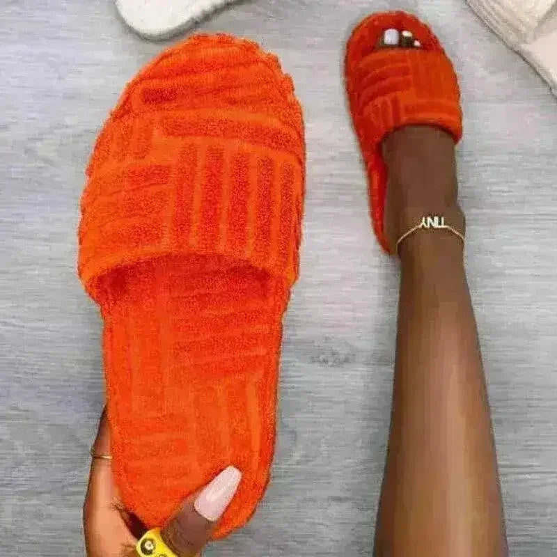 Orange fuzzy open-toe slide slippers with thick sole and slip-on strap.