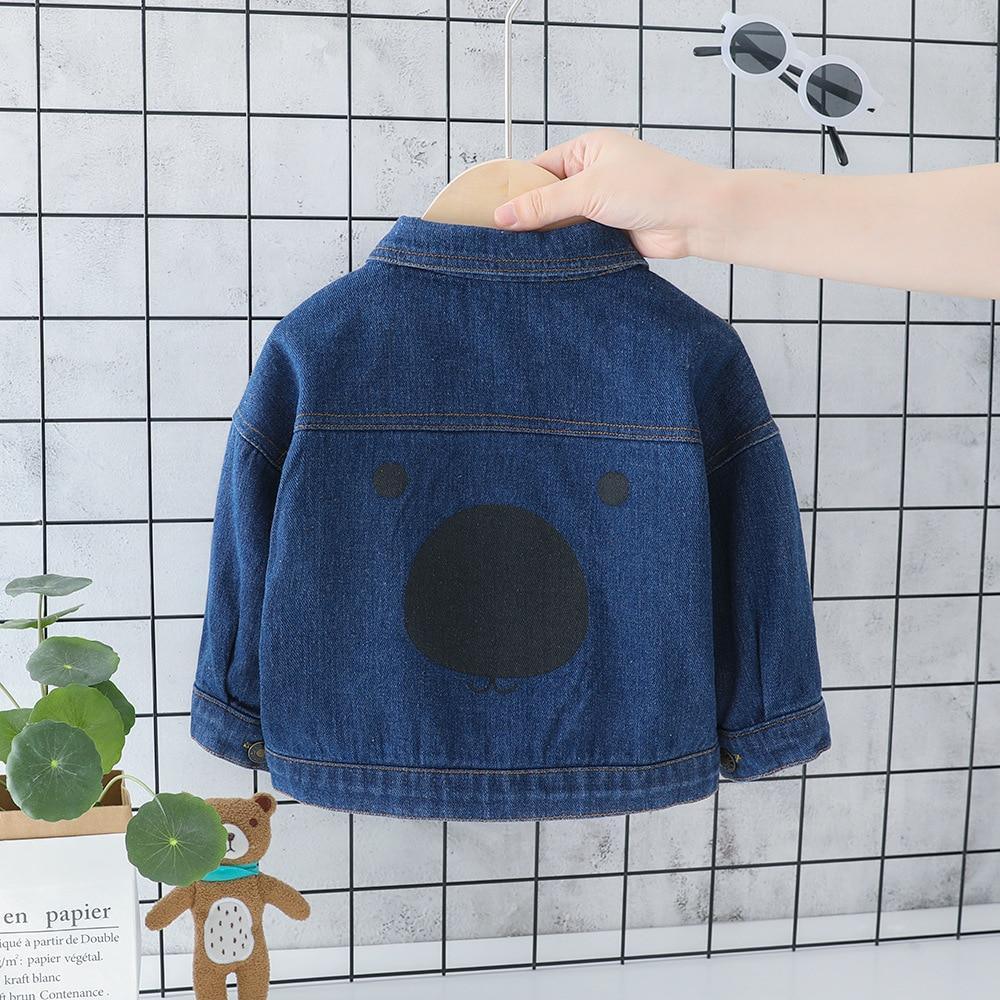 Blue denim baby jacket back with large bear-face applique and button details