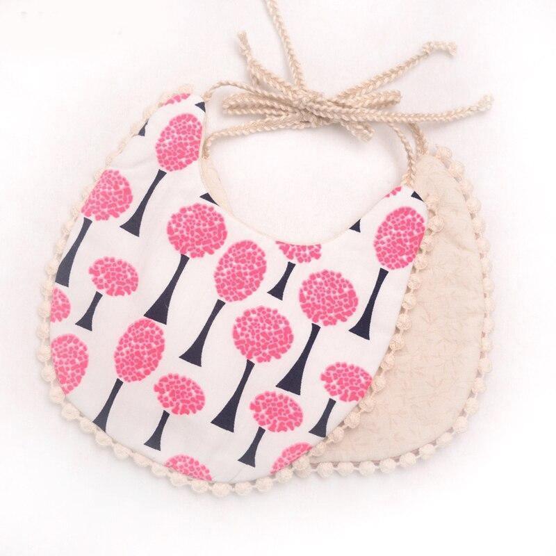 Toddler bib set with white mushroom print and pink pattern back, pom-pom trimmed edges