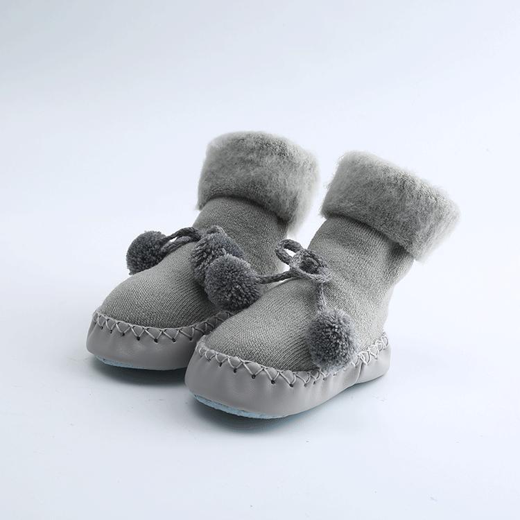 Newborn baby shoes in medium gray plush with pom pom bow and stitched sole