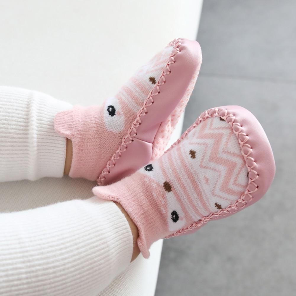 Pink baby socks shoes with cartoon face patch and stitched soft sole