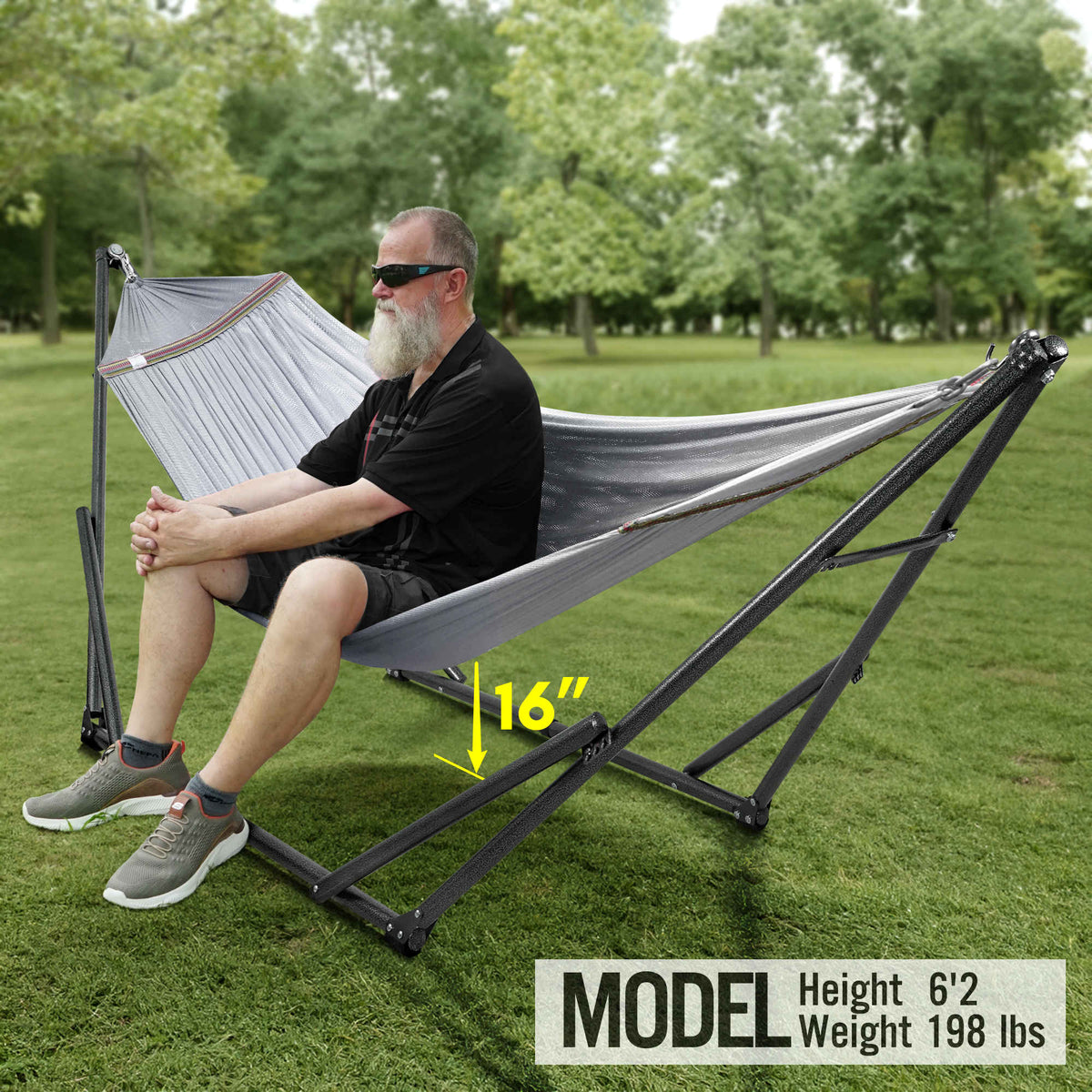Gray hammock with black folding stand, stretched between two adjustable end supports