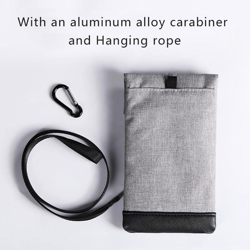 Gray vertical phone pouch with flap and snap, shoulder strap, and hanging carabiner