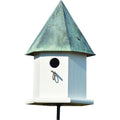 White bird house with verdigris copper roof, round entrance hole and metal hanging hook