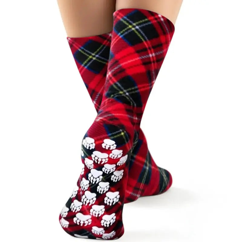 Kids' fleece socks in red and navy plaid with white paw-print pattern