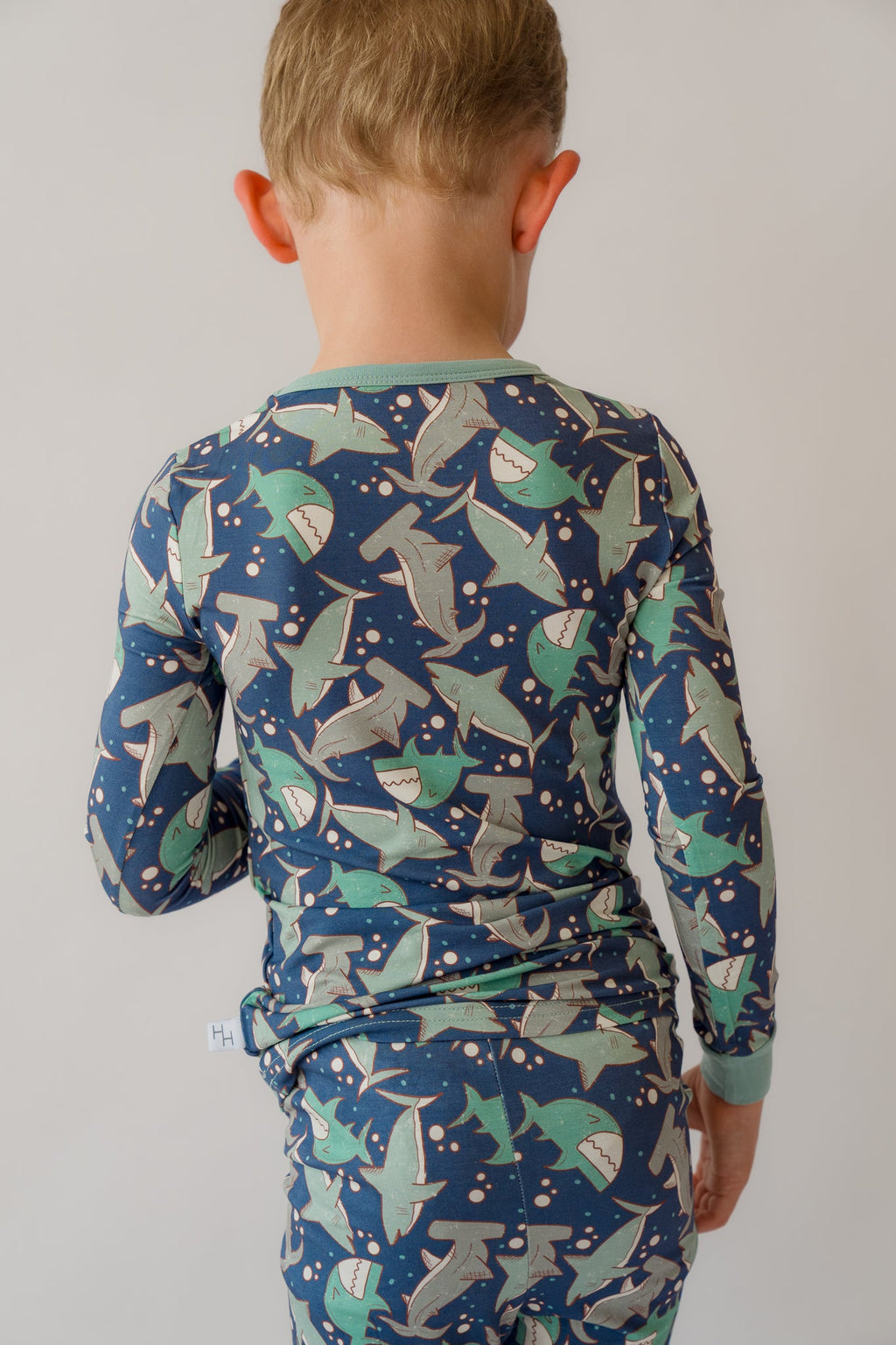 Blue long-sleeve pajama set with all-over shark print, crew neck top and pants