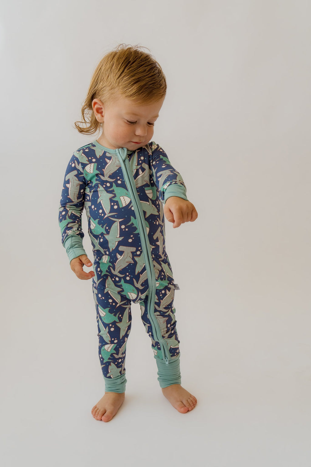 Teal-trim navy shark-print baby overalls with zip front and long sleeves