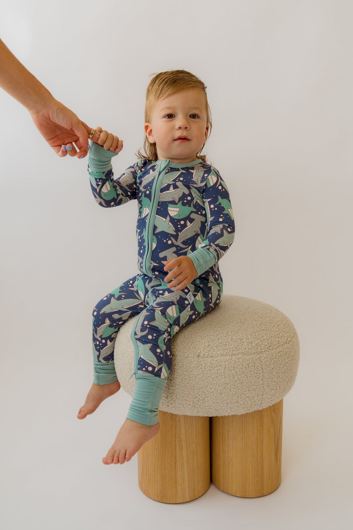 Navy and teal shark-print baby overalls, zip-front one-piece with foot cuffs