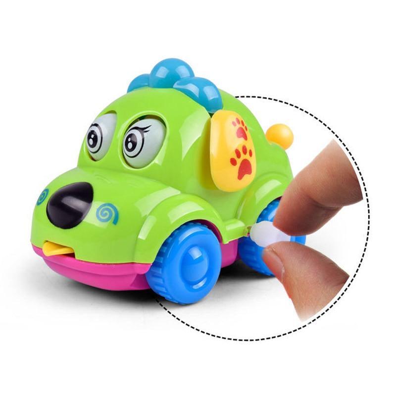 Green cartoon wind-up dog car rattle with blue wheels and paw detail on side