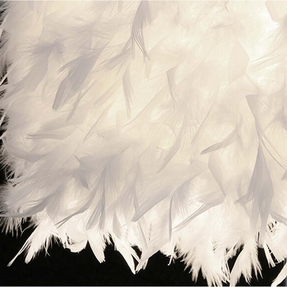White feather lamp shade with soft fringed edge for a heart-shaped table lamp