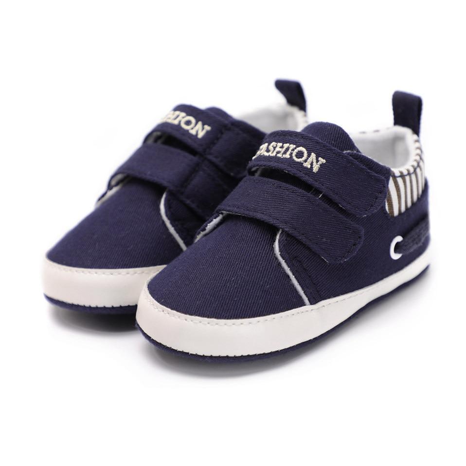 Pair of infant canvas sneakers, navy slip-on with striped lining and white sole