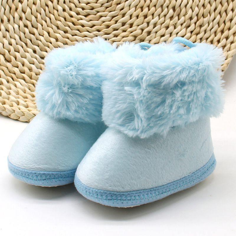 Light blue fleece first-walker boots with fluffy cuff and lace tie, soft sole.