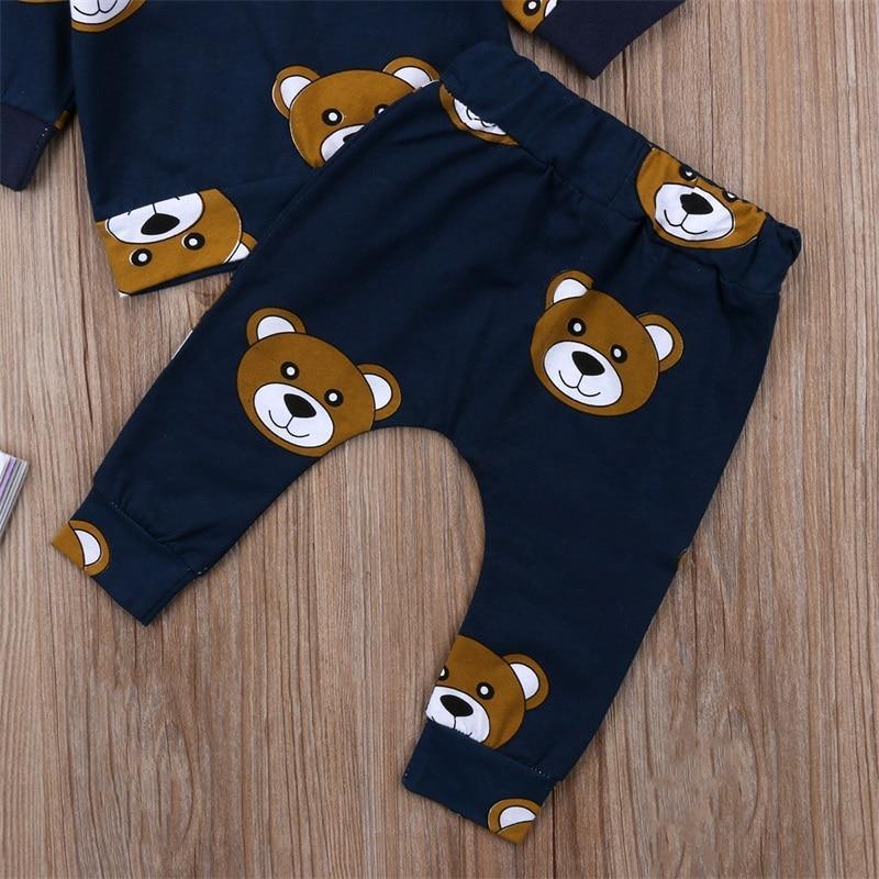 Navy long-sleeve boys pajama set with bear prints, pants laid flat