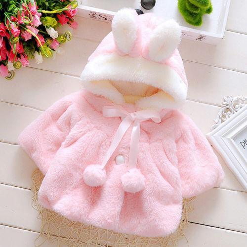 Pink faux-fur baby coat cloak with hood, bow tie, pom details and button front