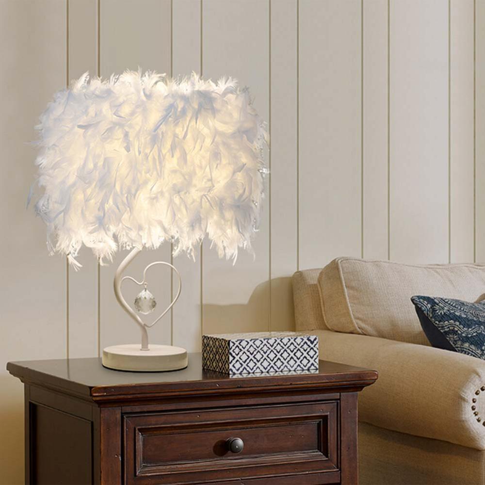 White feather heart-shaped table lamp on round white base with crystal charm