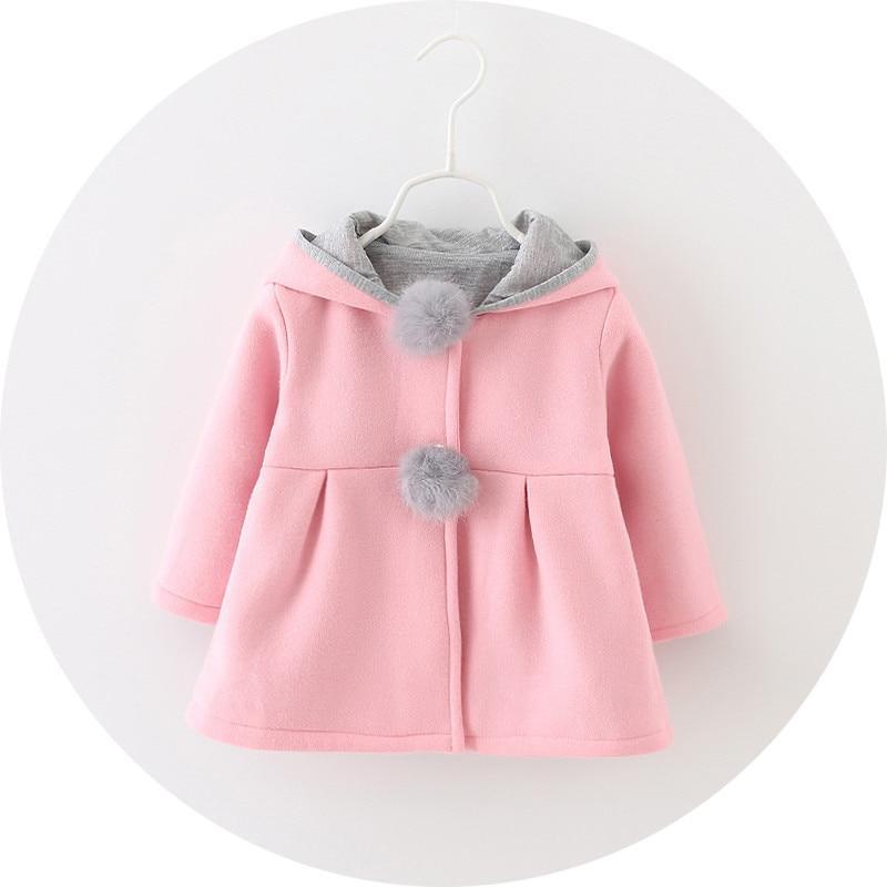 Baby girls winter coat, pink with gray hood lining and bunny pom-pom, front view
