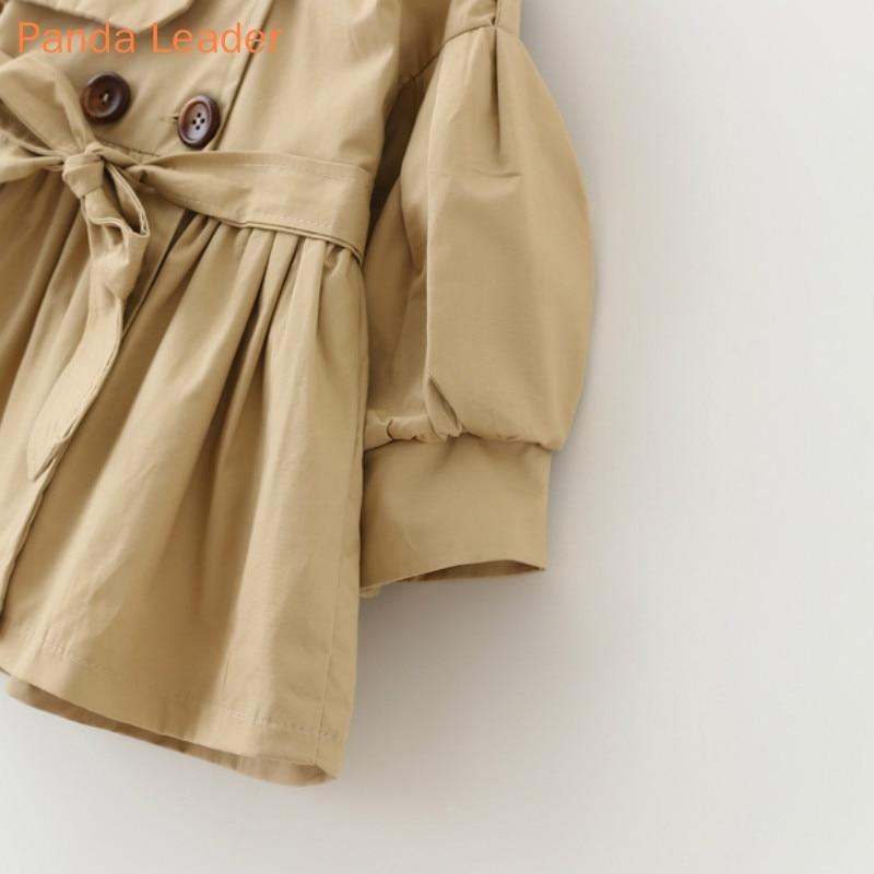 Khaki windbreaker coat close-up with puff sleeve and double-breasted buttons