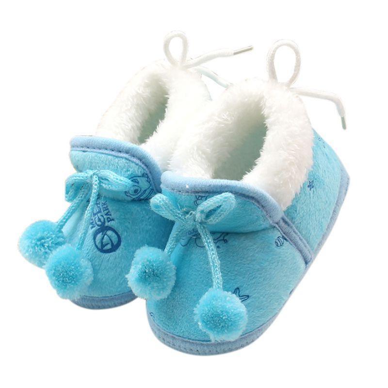Blue and white baby winter boots with fluffy cuffs, pom-pom and lace ties