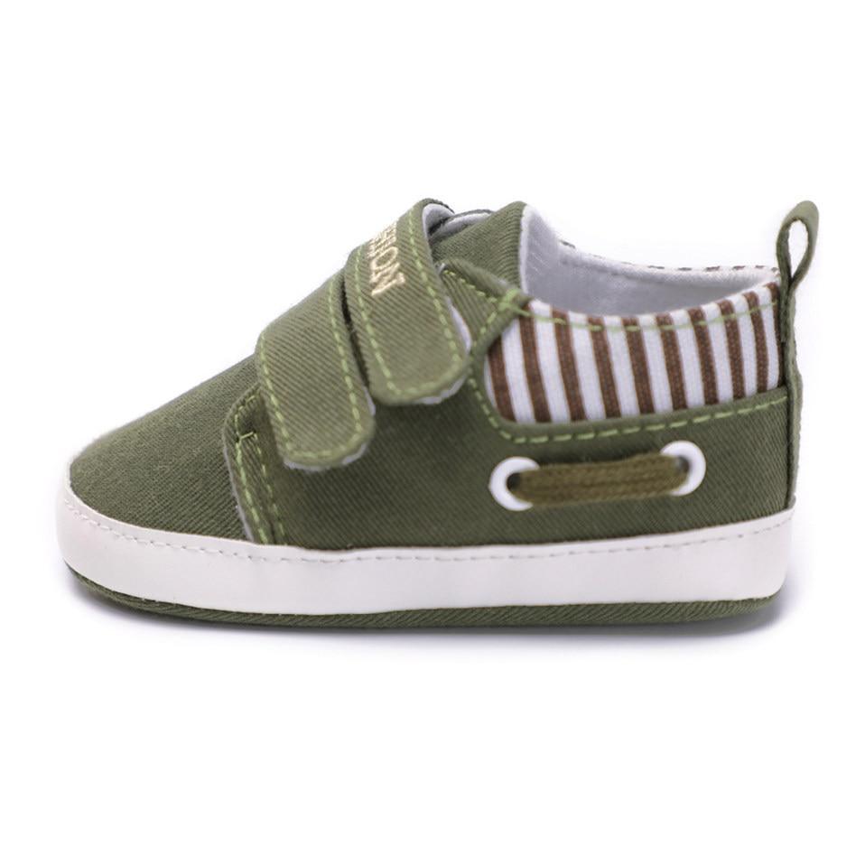 Infant canvas sneaker in light olive green with hook-and-loop straps and striped inner lining