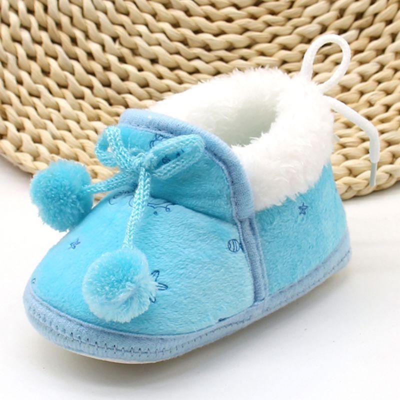 Light blue baby winter boots with fluffy white collar and pom-pom lace ties