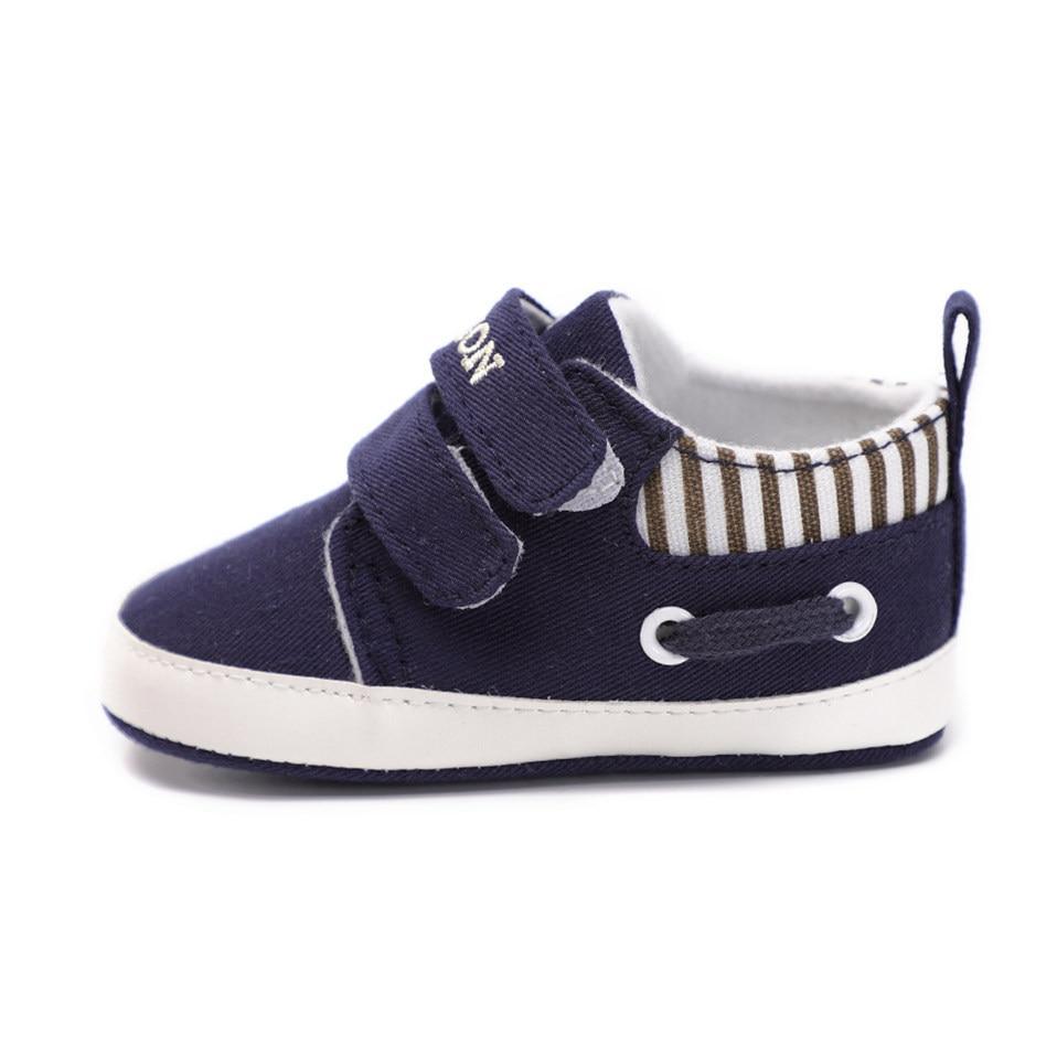 Infant canvas sneaker in navy blue with two hook-and-loop straps and white sole