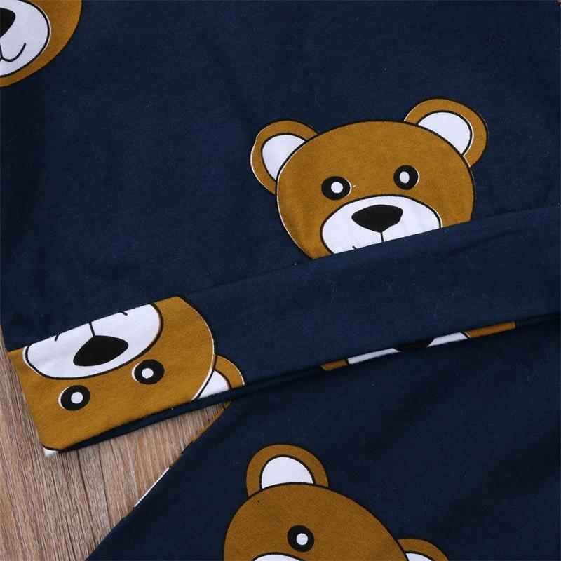 Close-up of navy pajama fabric with bear face print and curved seam