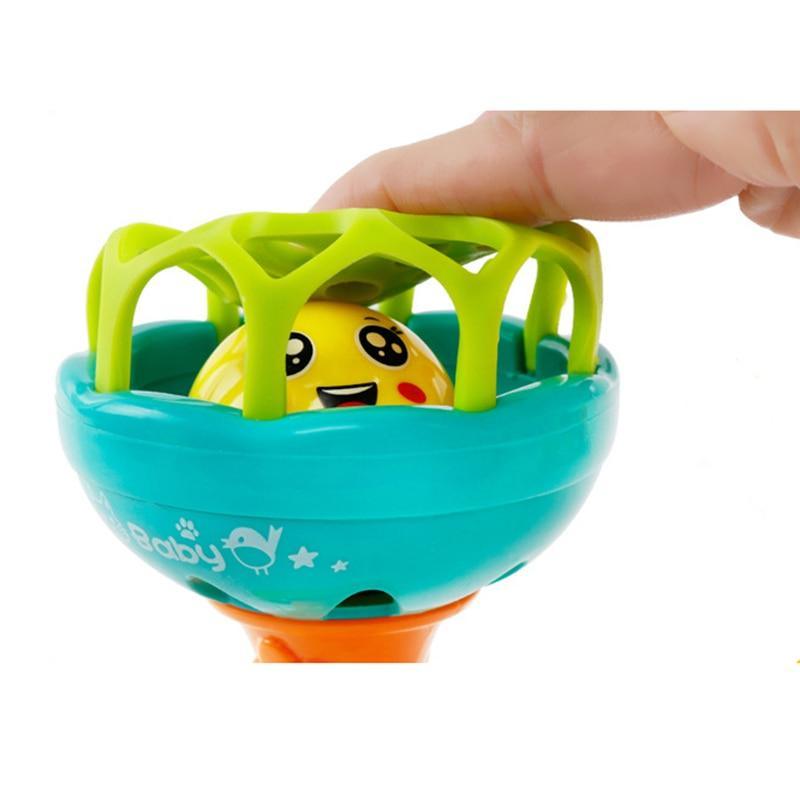 Baby plastic hand rattle with teal bowl and green handle, animal face inside