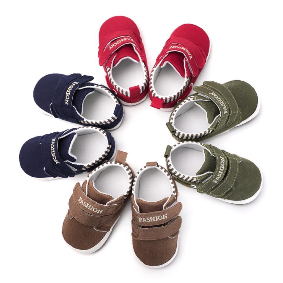 Set of infant canvas sneakers in red, navy, brown, and green with hook straps