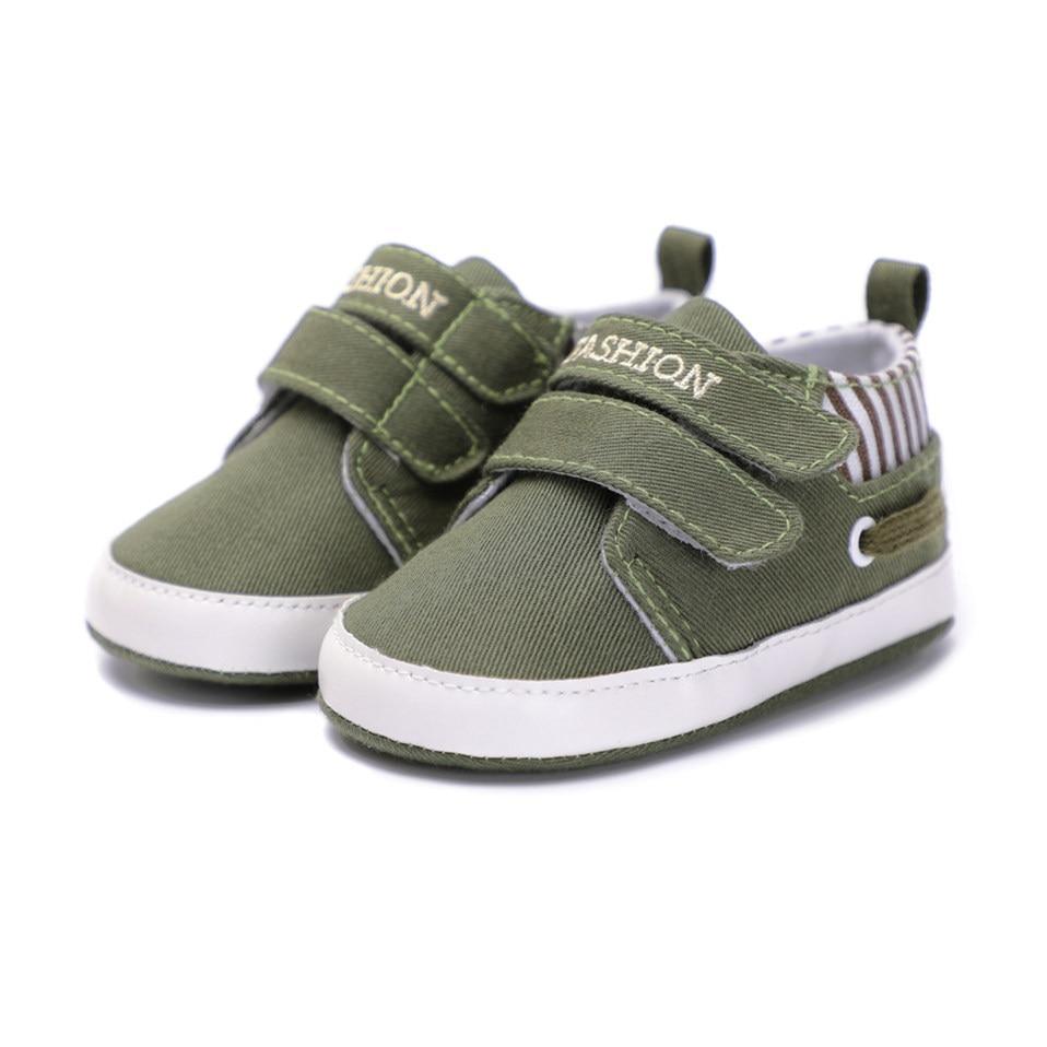 Infant canvas sneaker in olive green with two hook-and-loop straps and white sole
