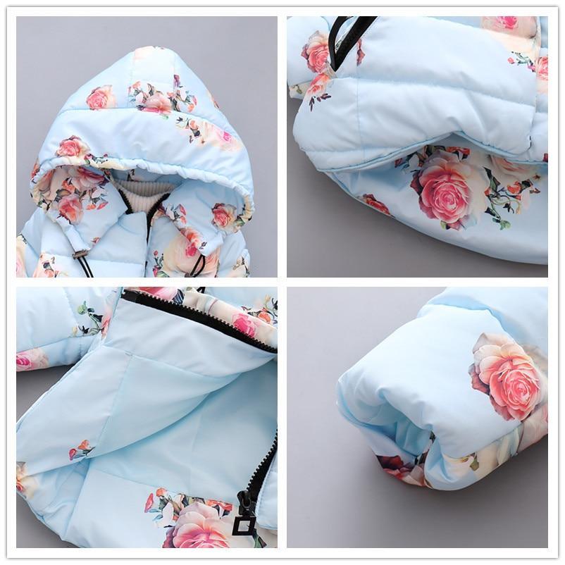 Infant light blue hooded puffer jacket detail view, floral print and zipper close