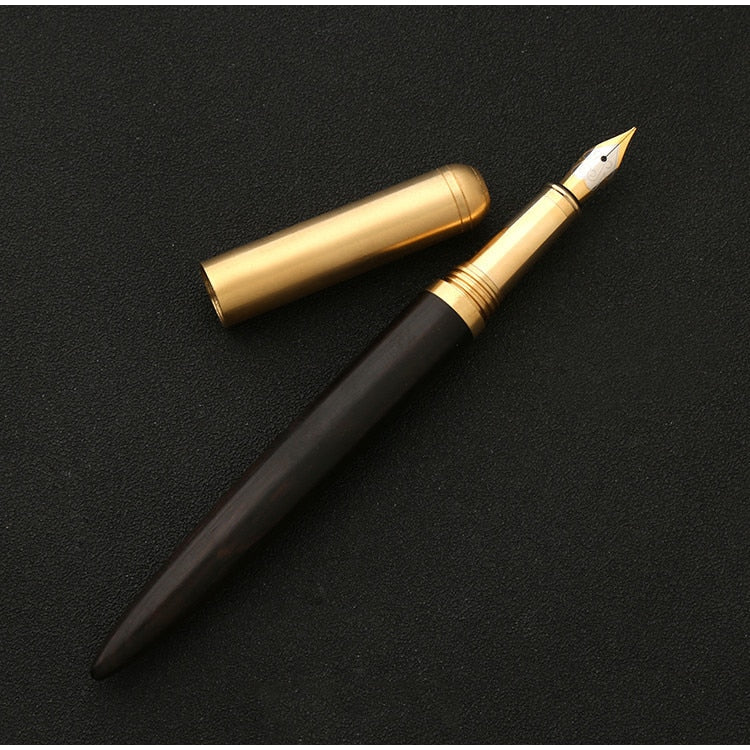 Handmade fountain pen with dark wood barrel and gold nib, brass clip