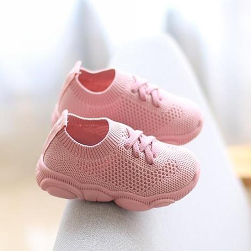 Light pink knit baby sneakers with lace-up front and padded sole