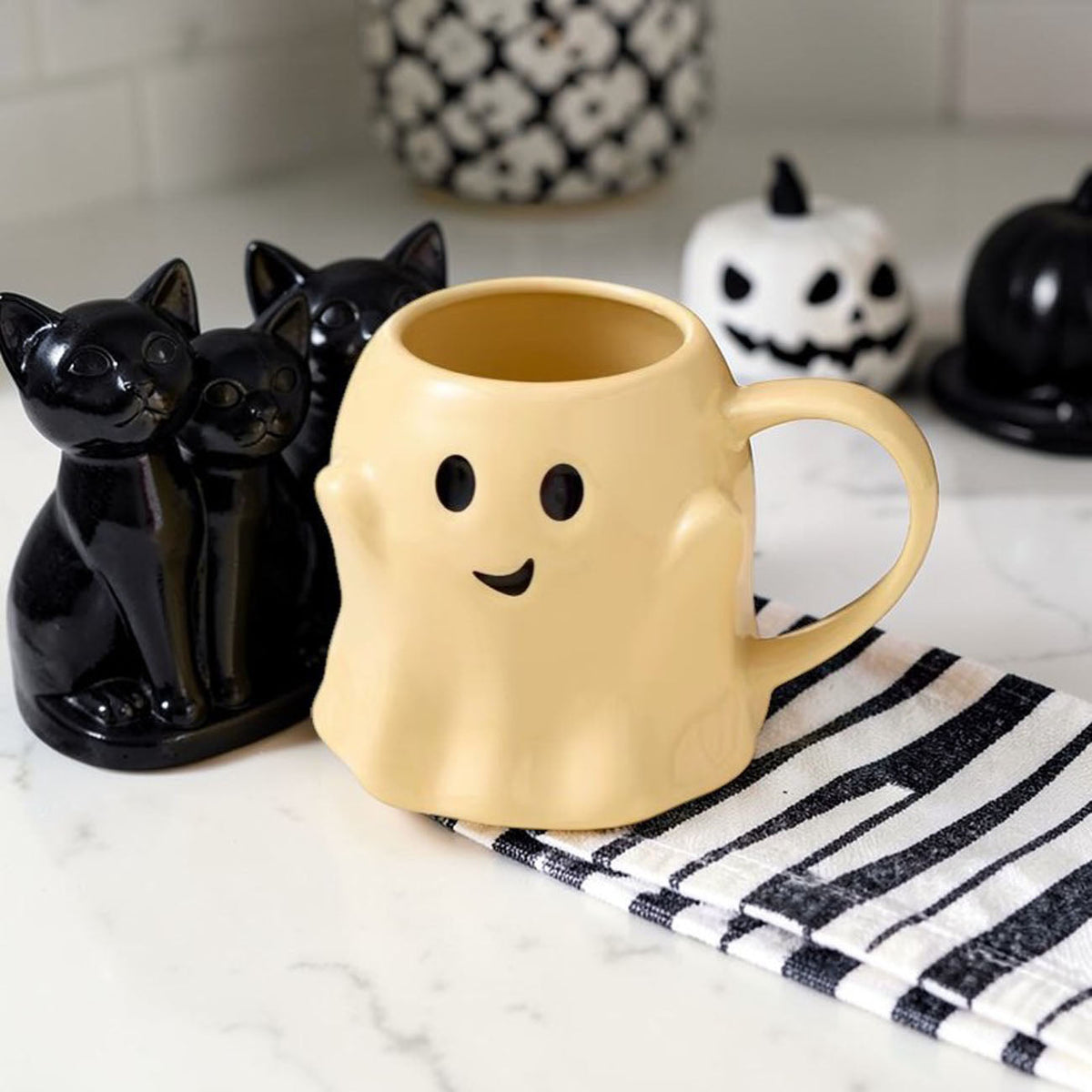 Yellow ghost-shaped ceramic mug with smile face and curved handle